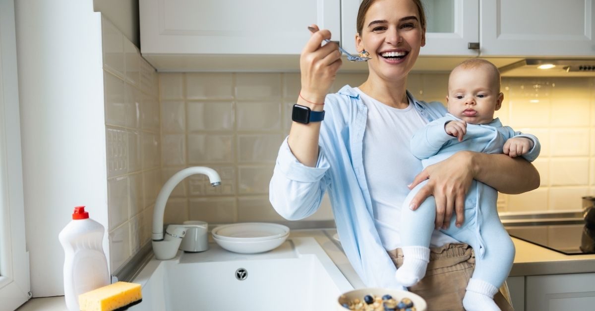 person holding baby while eating a nourishing breakfast.