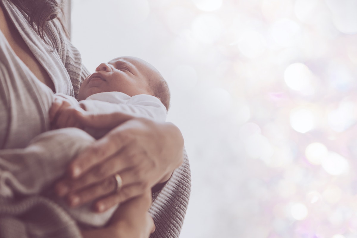 parent holding baby before they leave for work.