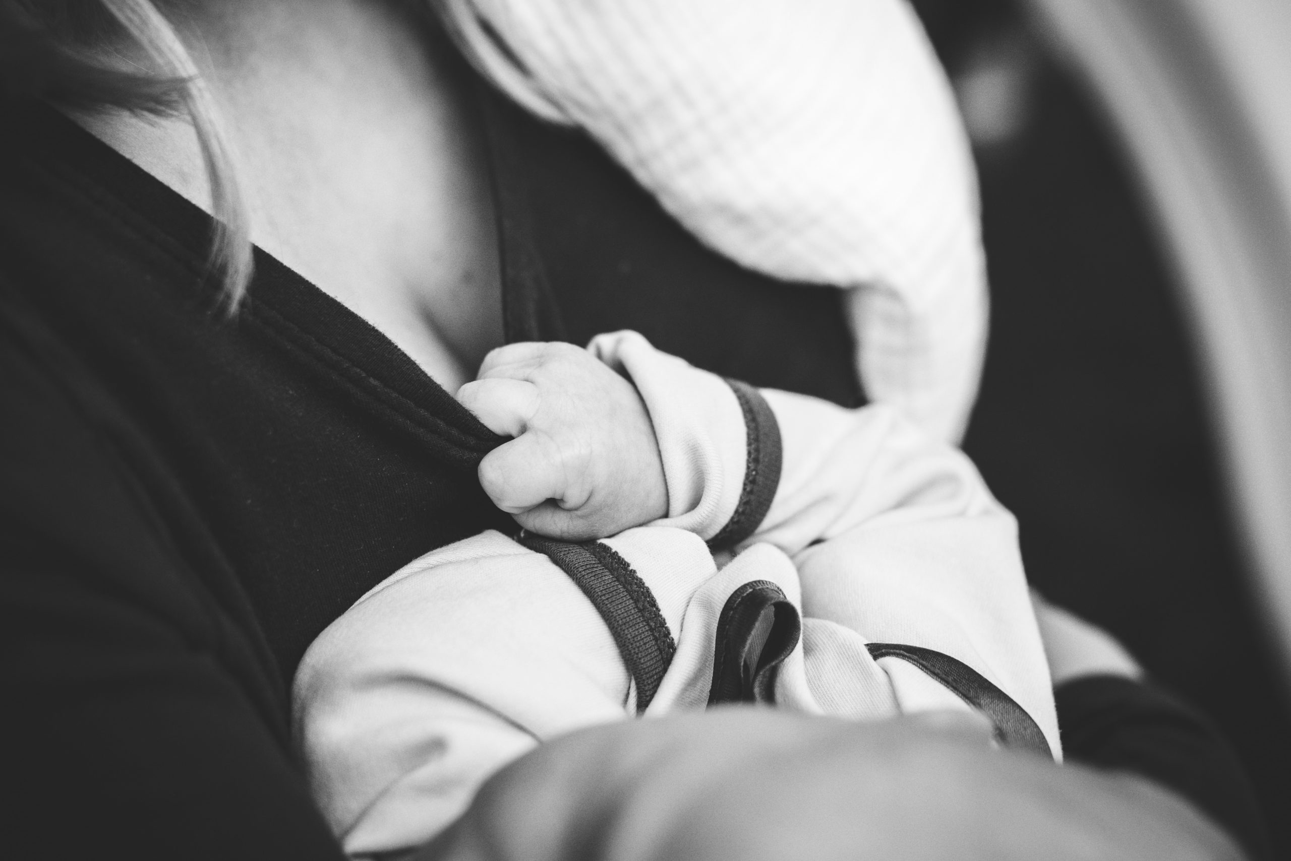 Person holding baby after a feeding.