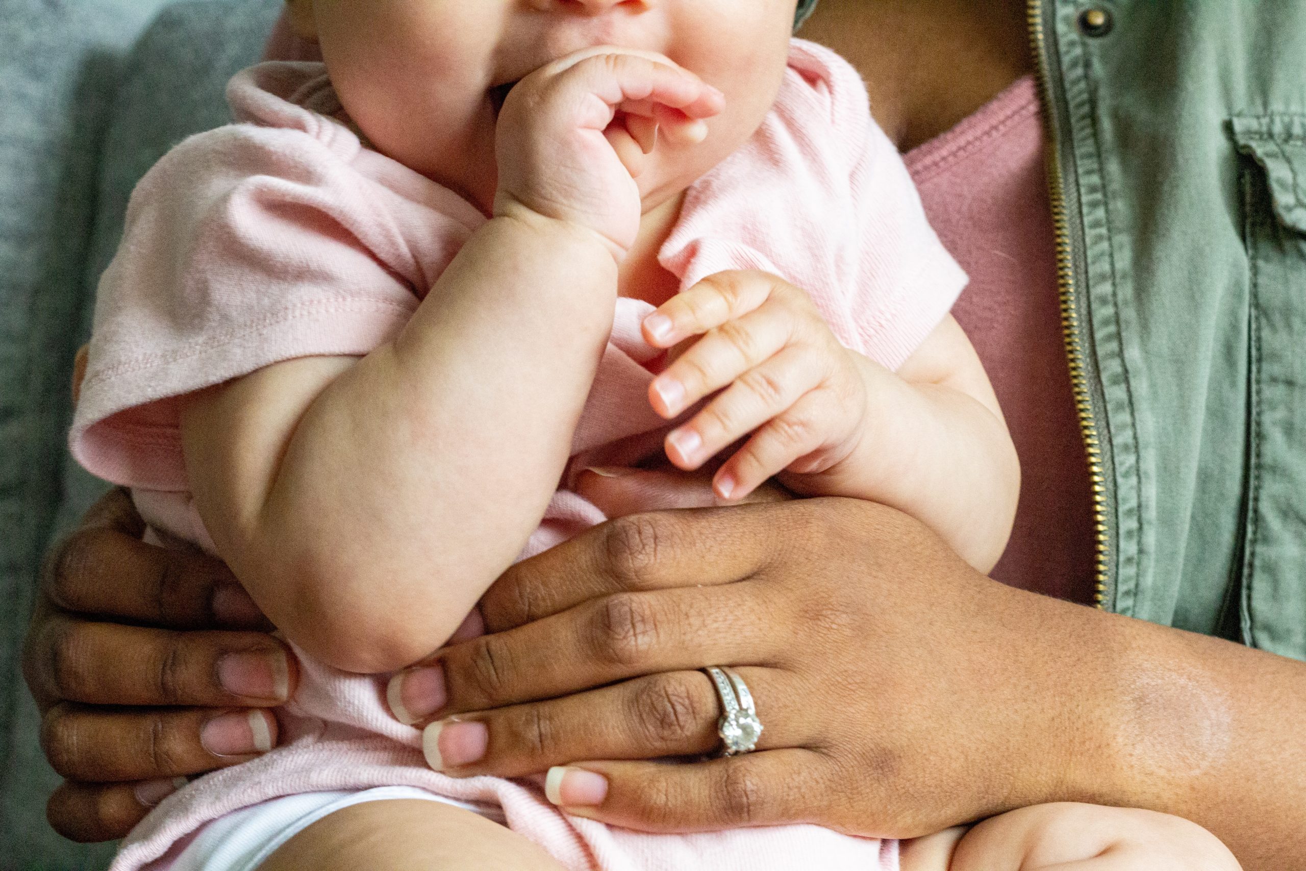 ABG Answers 6 Frequently Asked Questions about Postpartum Care on Austin Doula Care baby sitting in postpartum doula's lap