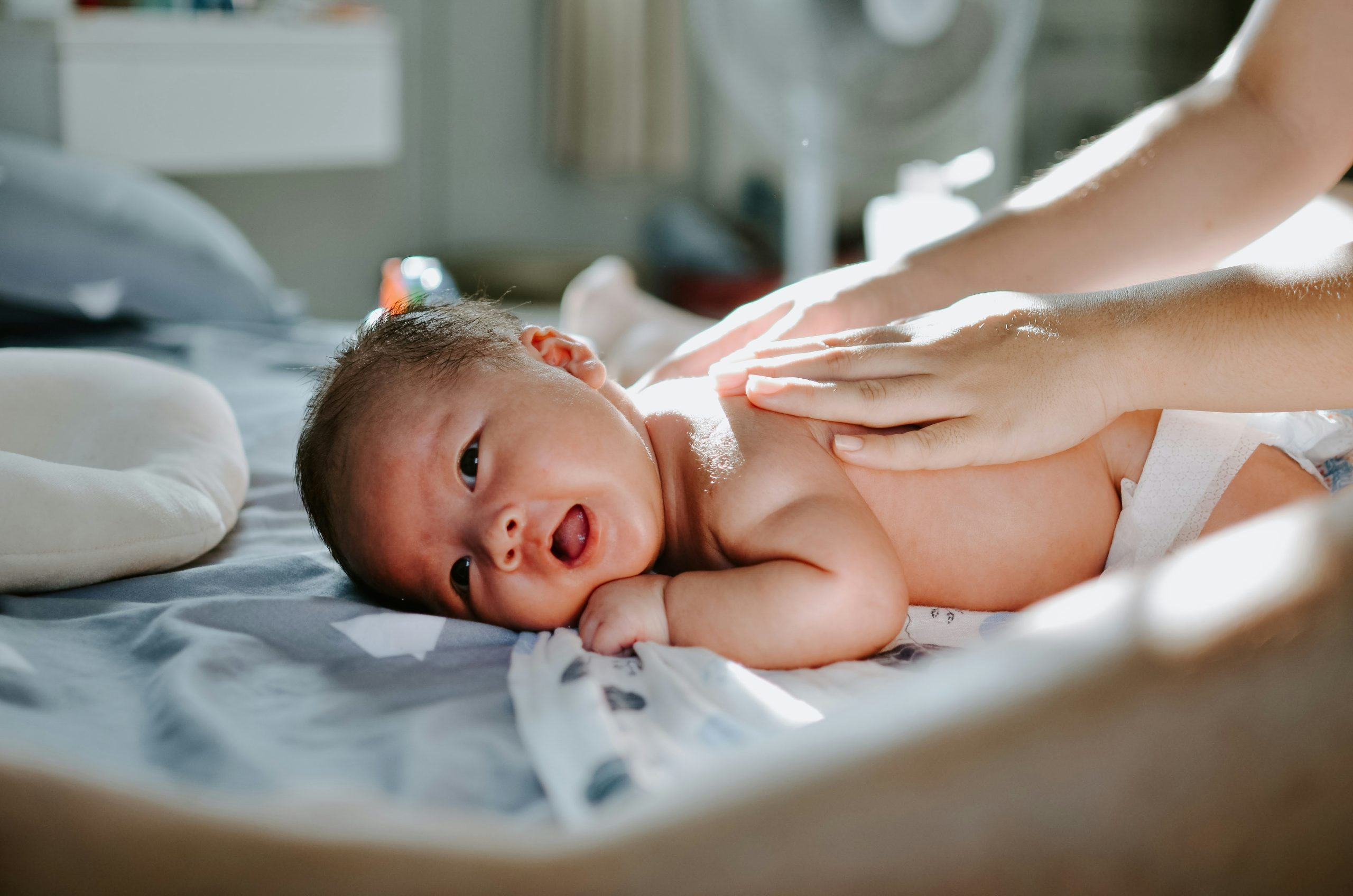 parent doing massage on their baby's back