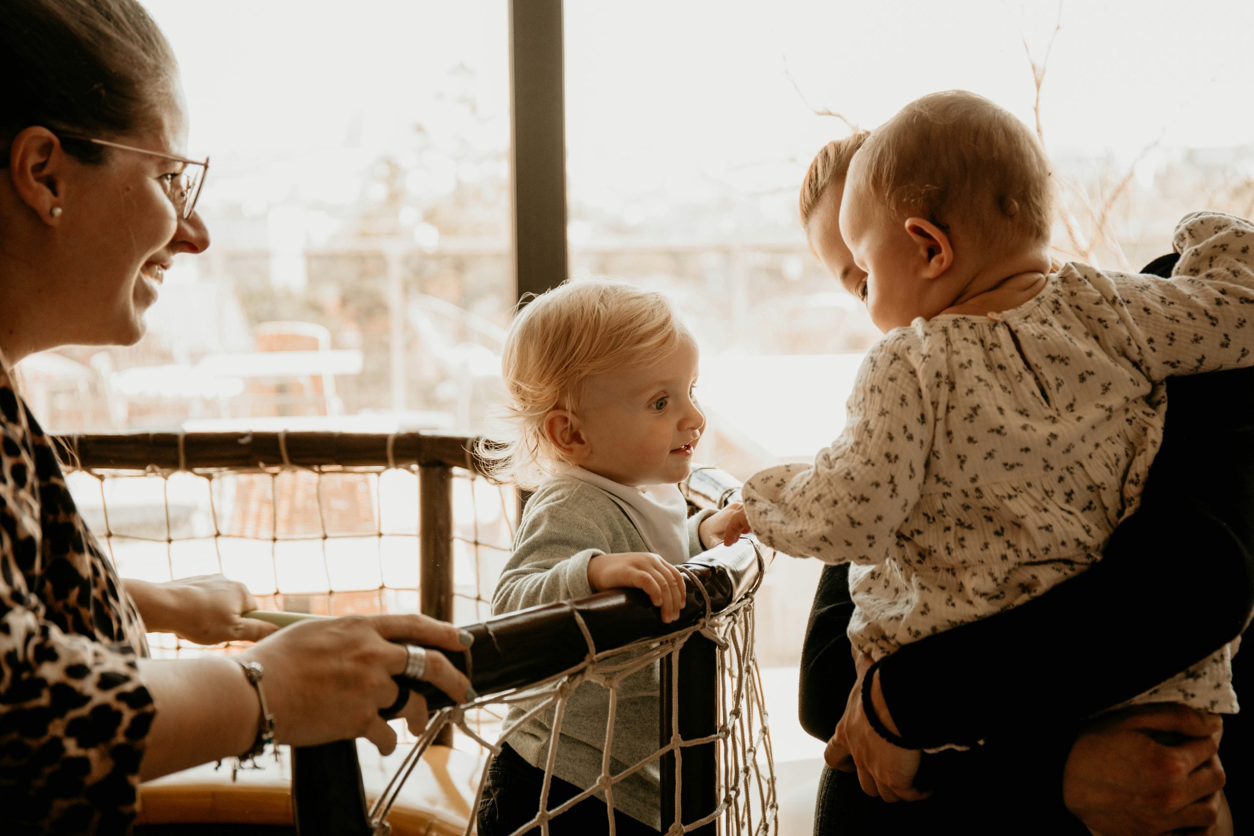 two parents and their babies looking at one another.