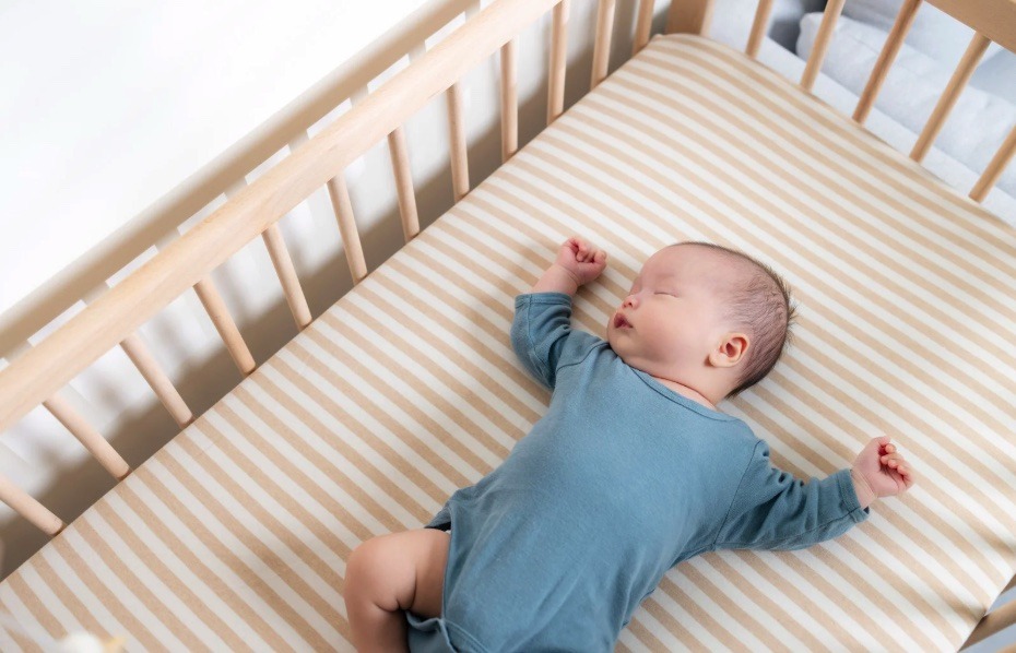 baby sleeping on their back in their crib.