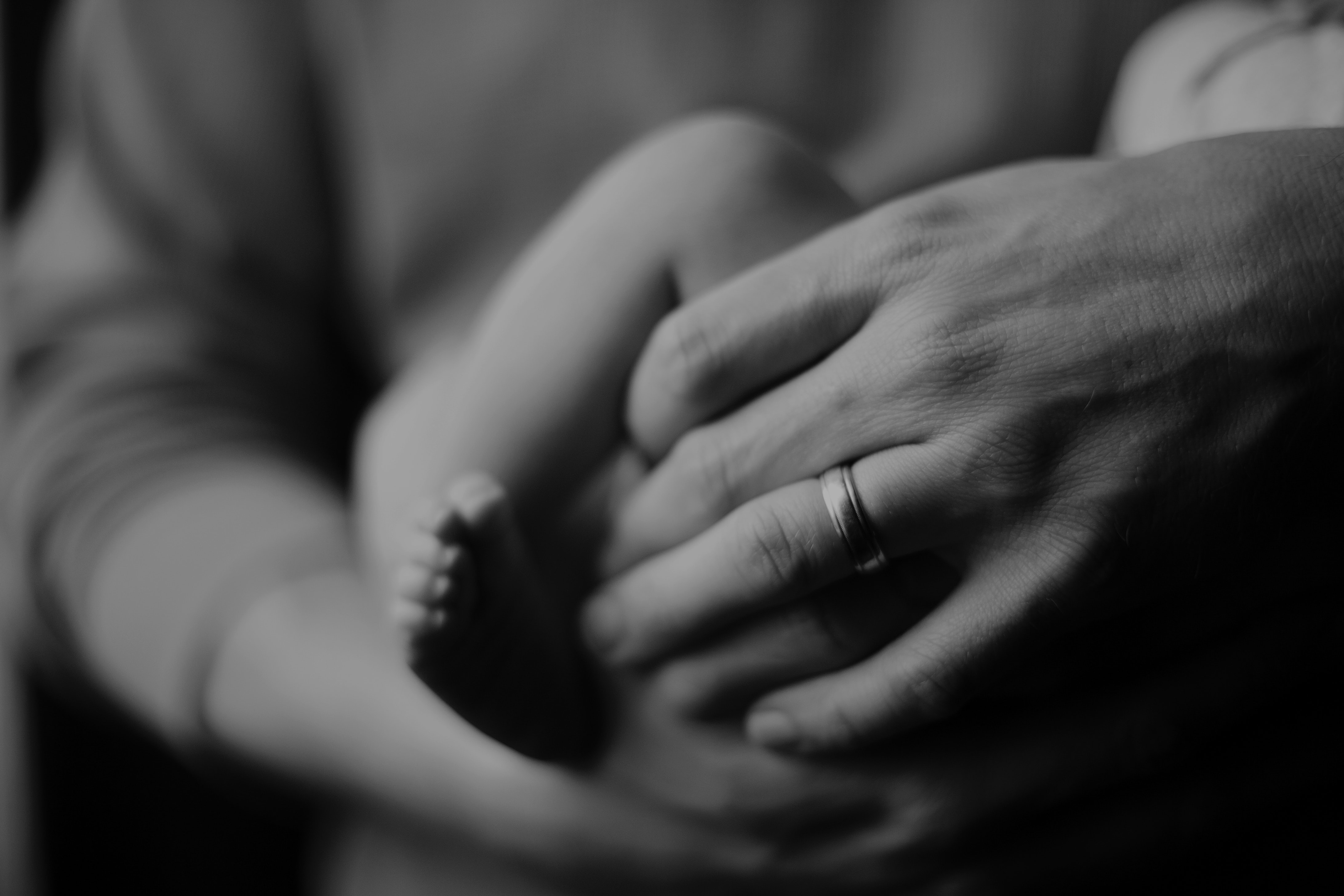 parent's hand holding baby.