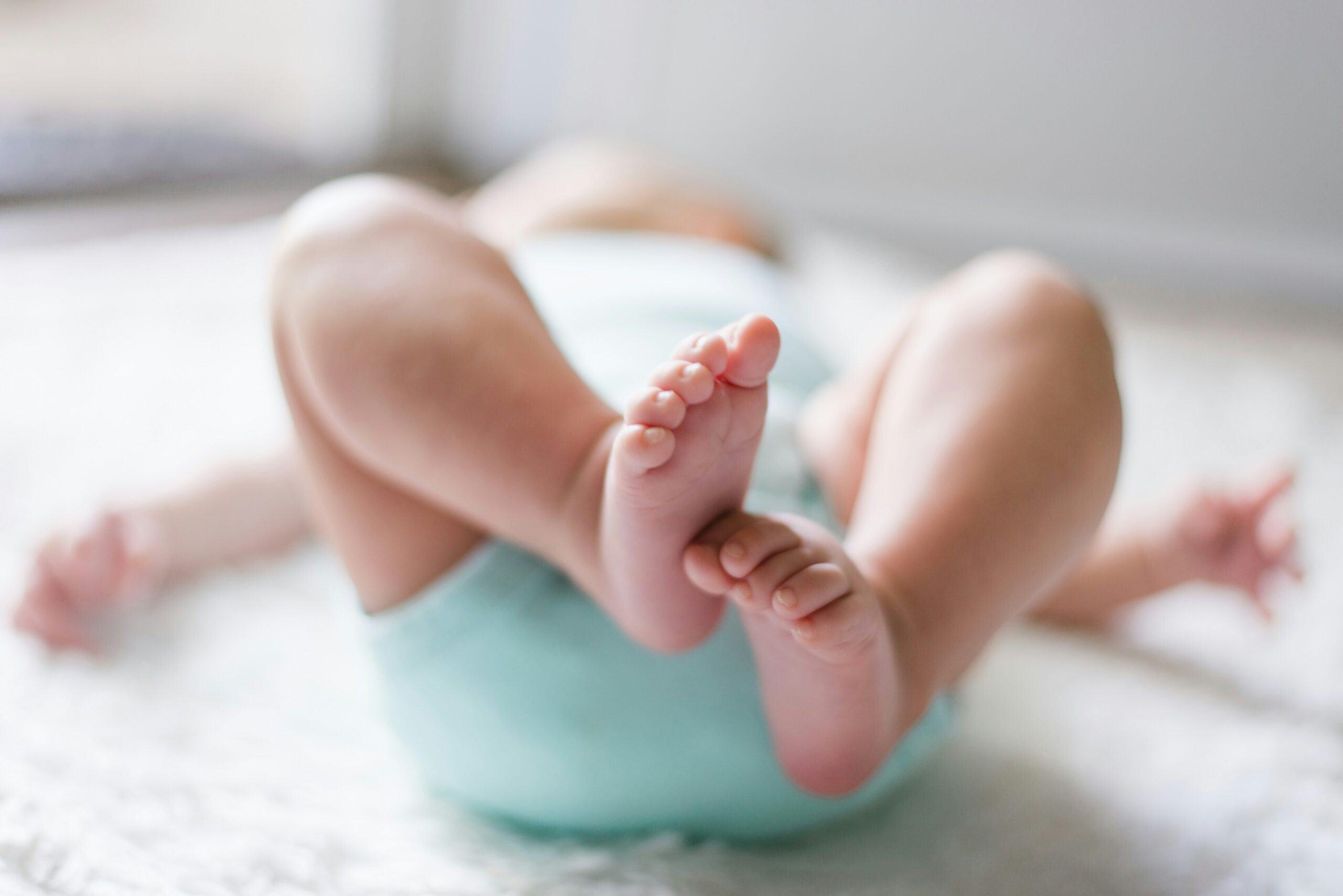 view of a baby's feet as they lay in a crib